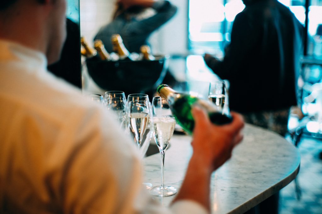 Waiter Pouring Champagne in Glass